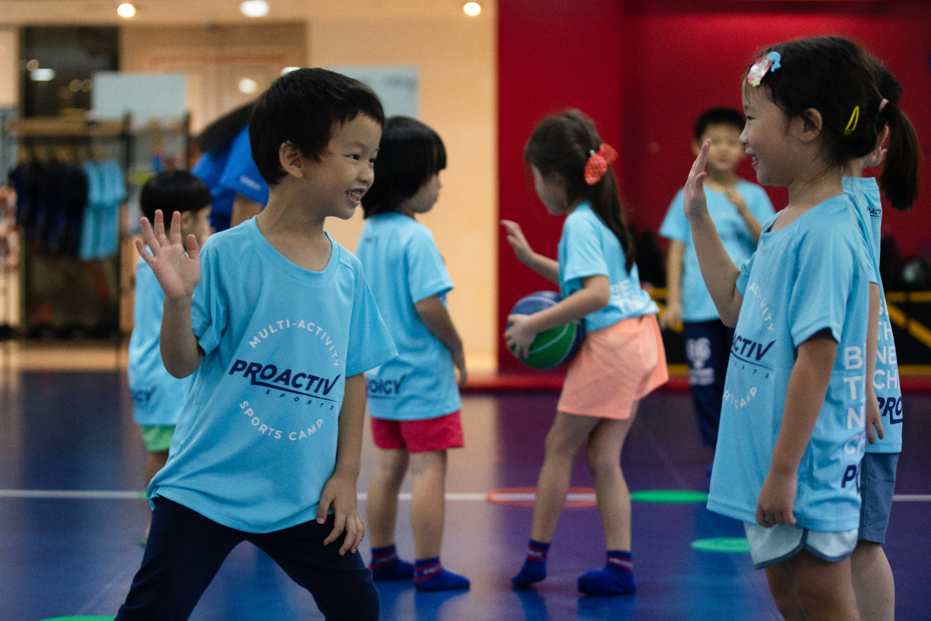Young campers high-fiving during a Prodigy Multi-Activity Camp session
