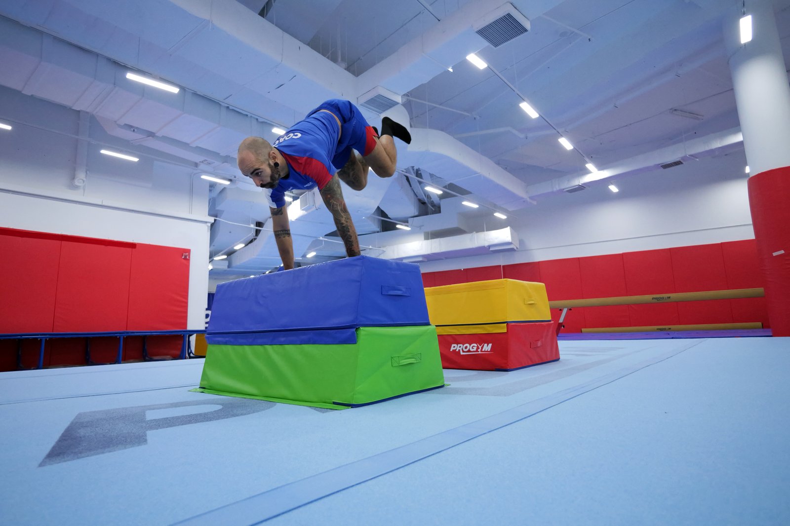 Dive kong vault over an obstacle in a ProActiv Sports parkour class