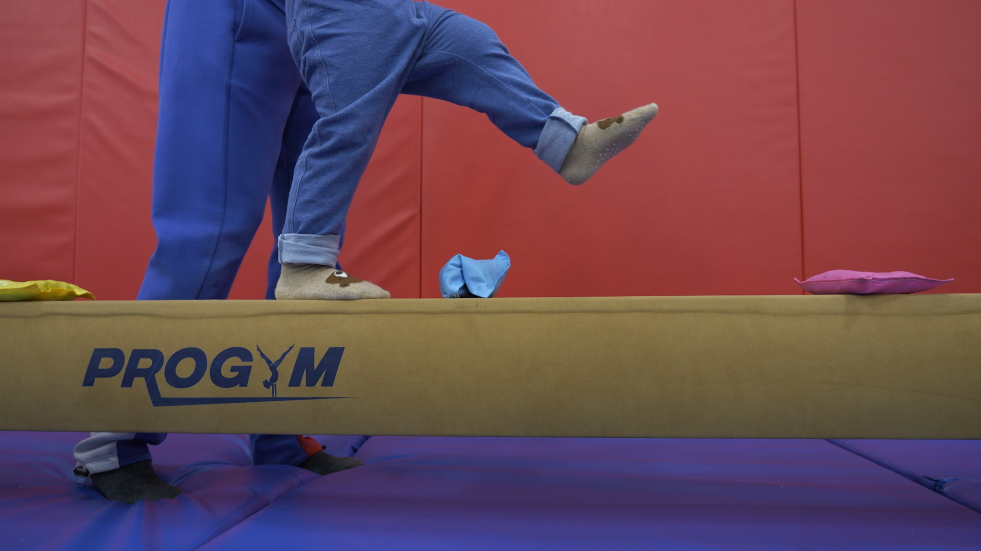 Toddler walking along ProGym balance beam with bean bags