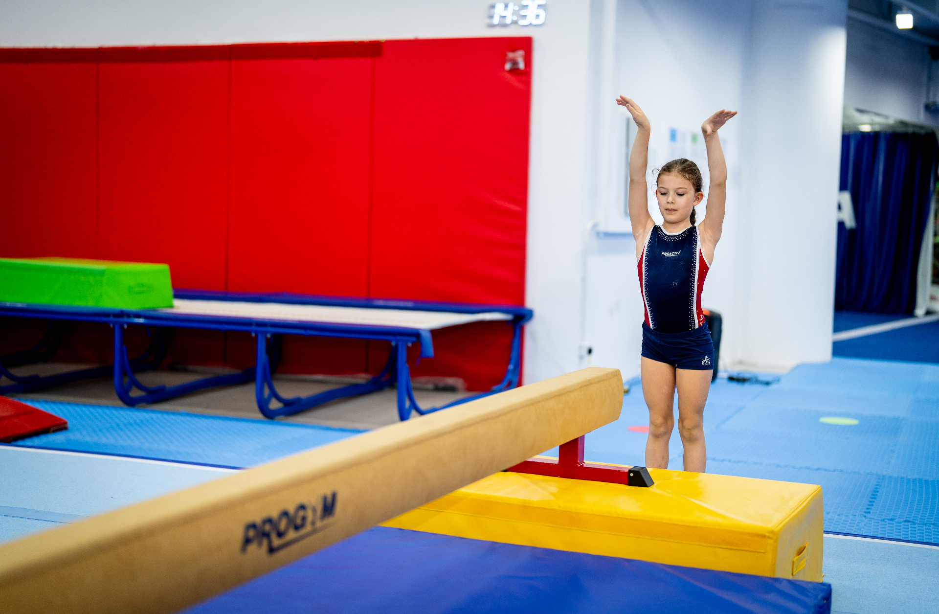 Advanced competitive gymnast performing a handstand during competition