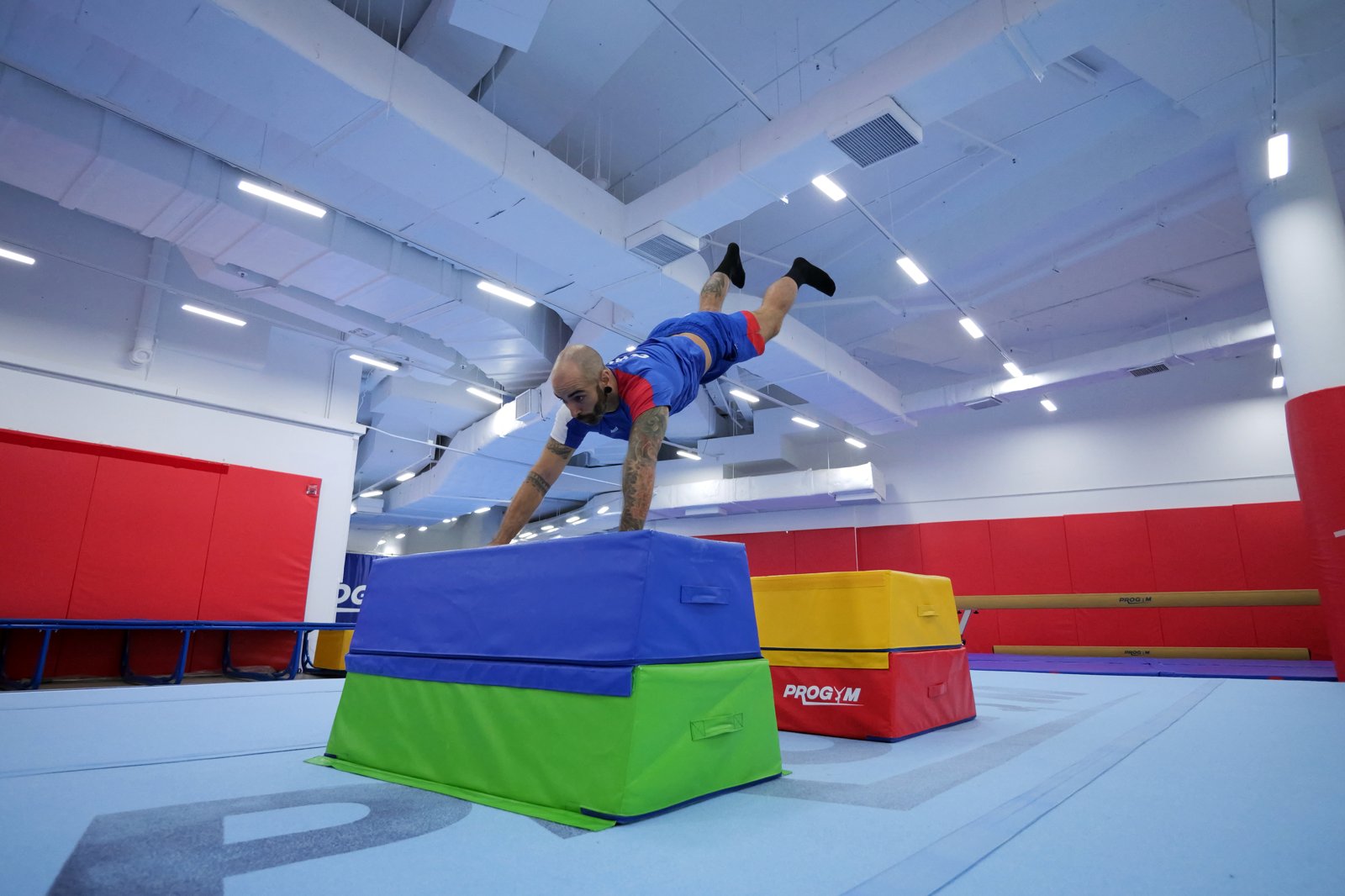 Athlete performing a double kong vault over parkour blocks
