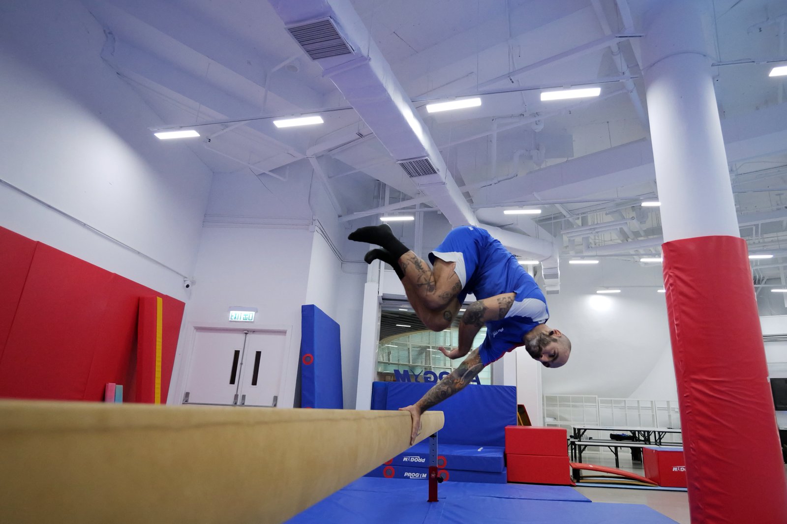 Palm spin on a beam during parkour skill practice