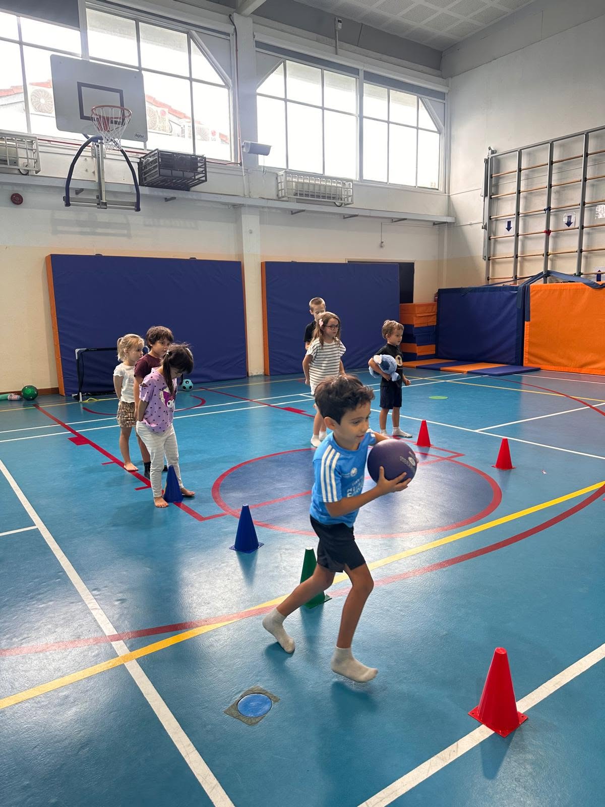 Children enjoying team activities at Holland International School camp