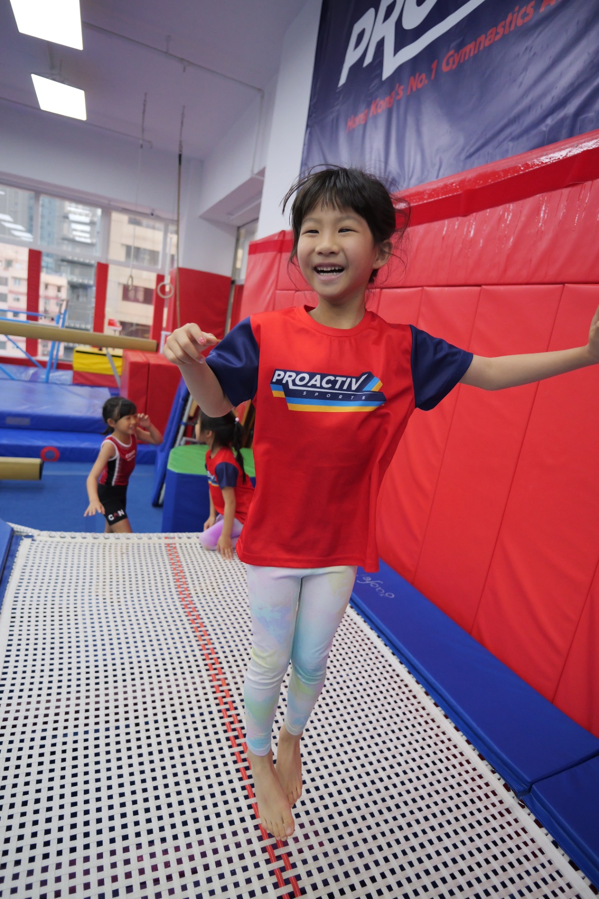 Child bouncing on the trampoline at a ProActiv Hong Kong Gymnastics Camp