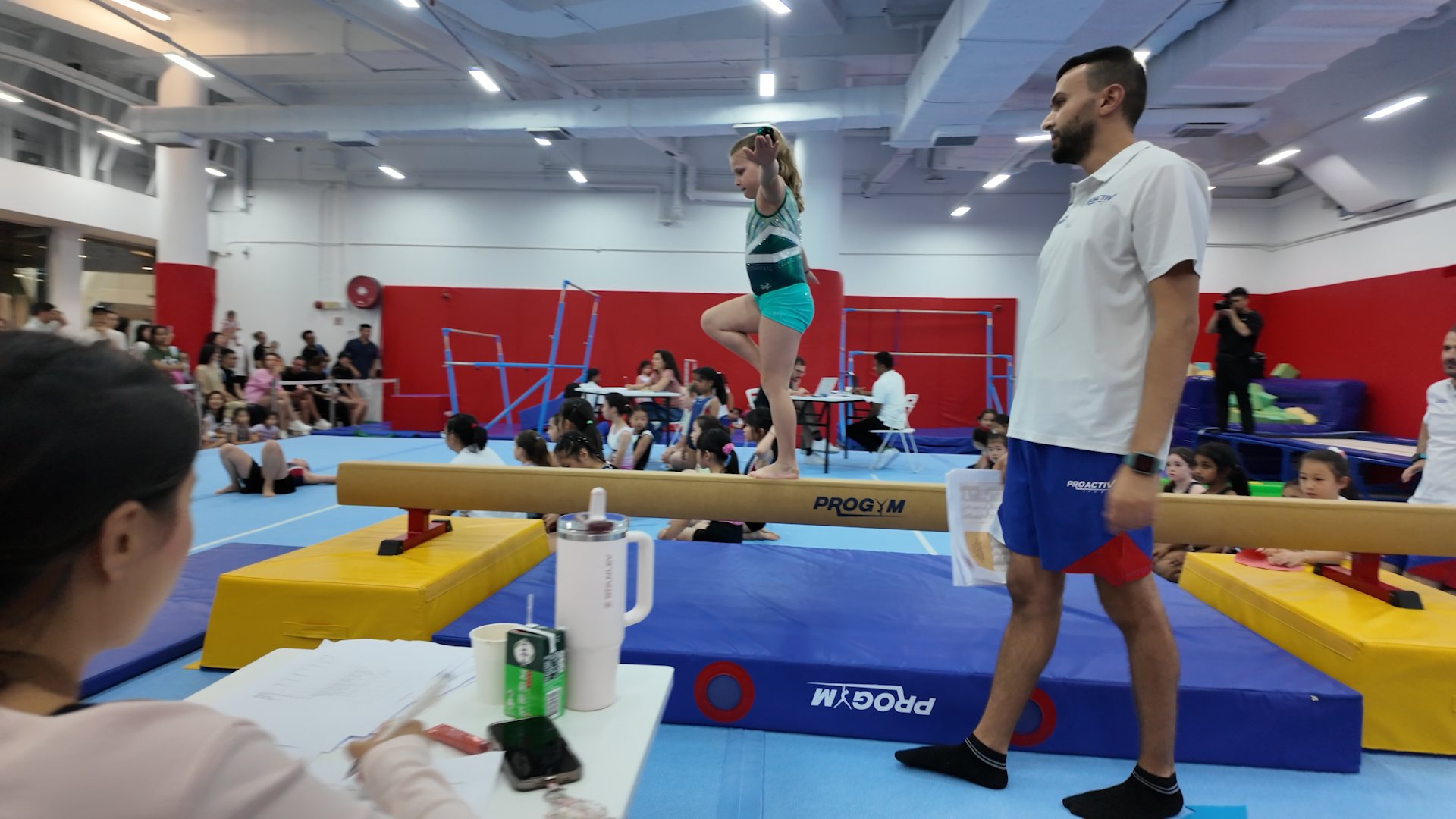 Young gymnast competing on the balance beam at the ProActiv Sports Friendly Competition