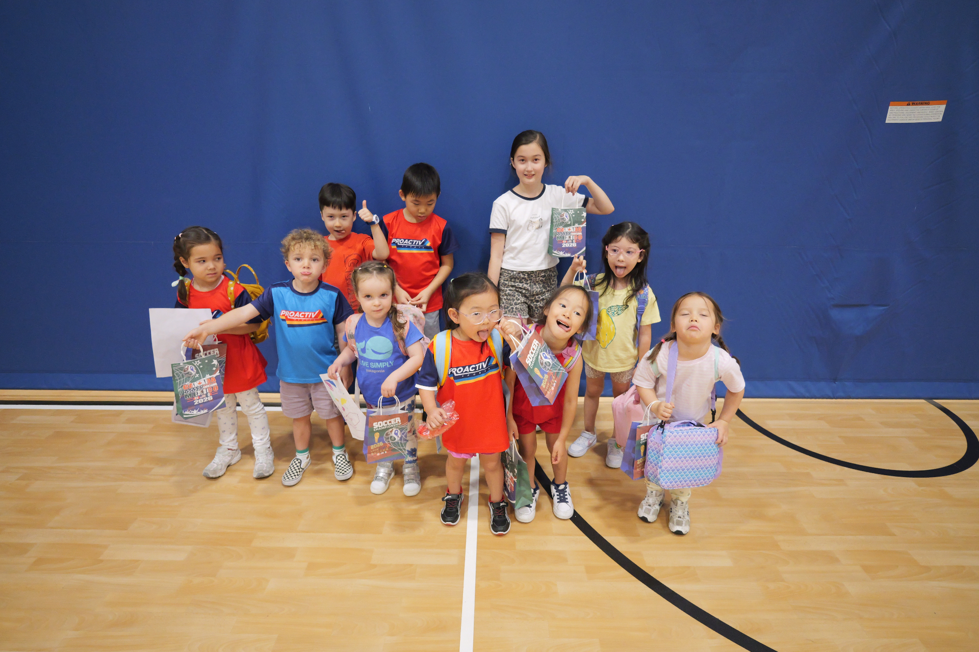 Group photo of children with soccer prize bags at a ProActiv Hong Kong Multi-Activity Camp