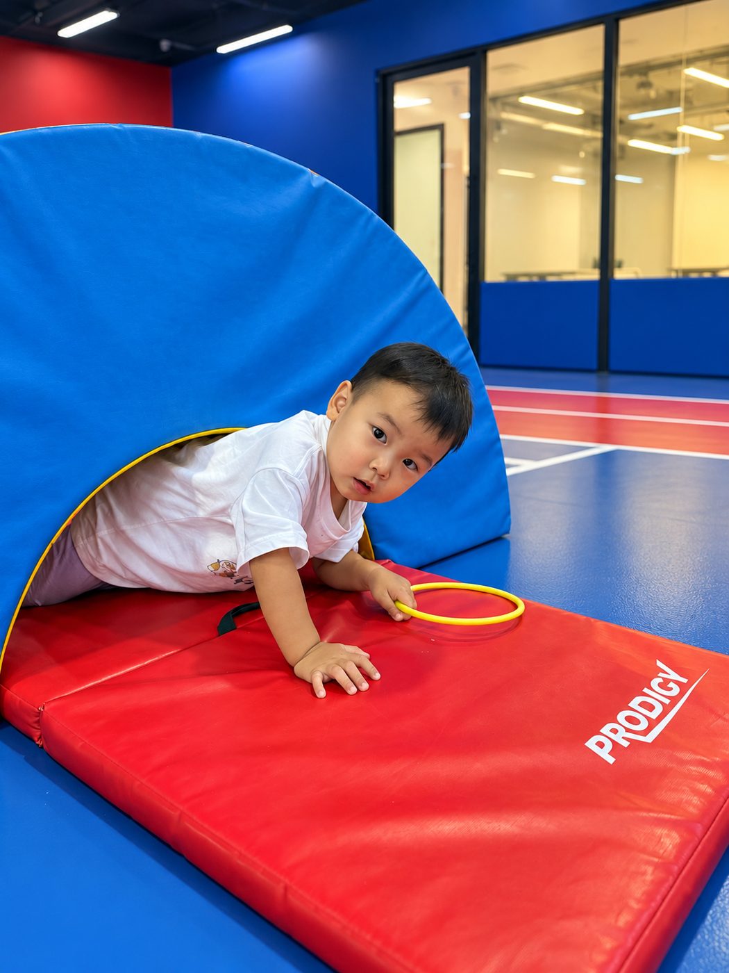 Coach guiding toddlers through a movement activity in Singapore
