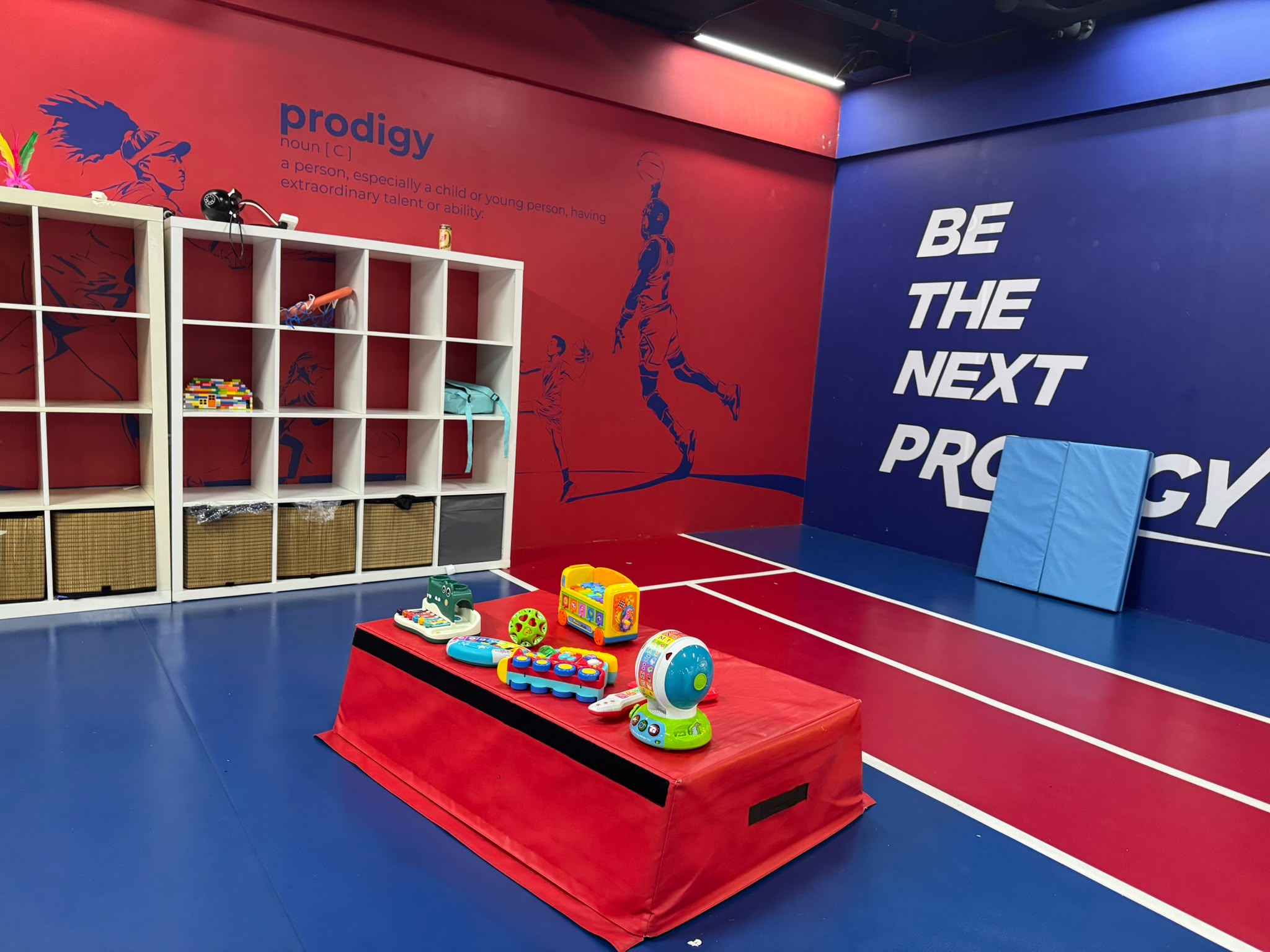 Parent supporting a toddler during open gym play at Prodigy at Katong Point